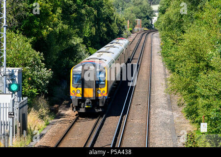 Holton Heath Station, Dorset, UK.  26th June 2018. UK Weather.   A London bound train at Holton Heath with delays on South Western Railways in Dorset after a small fire under a train between Surbiton and Weybridge blocked the West bound line.  This incident is on top of the speed restrictions on the railways due to the risk of the lines buckling due to the hot temperatures from the current heatwave.  Picture Credit: Graham Hunt/Alamy Live News Stock Photo