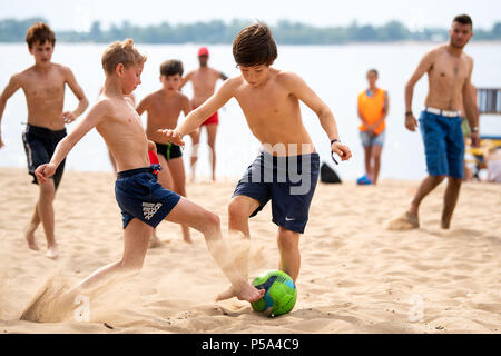 Samara, Russia. 26th June, 2018. Soccer, World Cup 2018: Boys playing soccer at the banks of the river Volga. Credit: Marius Becker/dpa/Alamy Live News Stock Photo