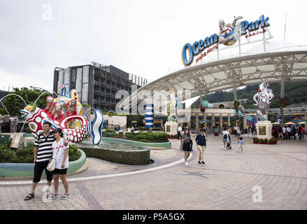 Tourists take pictures at the amusement and animal theme Ocean Park