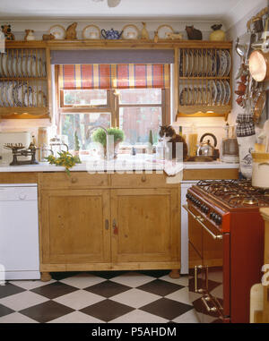 https://l450v.alamy.com/450v/p5ahdm/wooden-plate-racks-either-side-of-window-with-red-blind-above-sink-in-cottage-kitchen-with-blackwhite-chequer-board-floor-p5ahdm.jpg