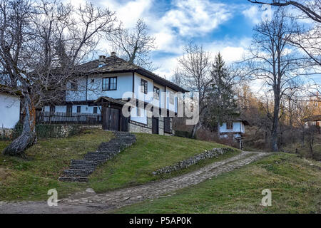 white wooden house and cobbled street in old Bozhentsi village in Bulgaria Stock Photo
