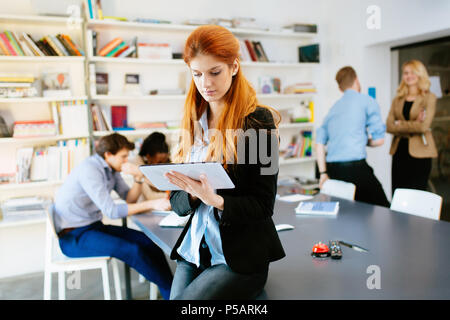 Businesswoman holding tablet in office Stock Photo