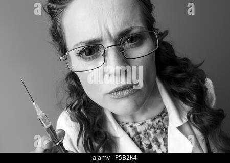 pediatrician doctor in white medical robe with syringe isolated on Stock Photo