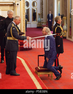 Singer and songwriter Barry Gibb is knighted by the Prince of Wales during an Investiture ceremony at Buckingham Palace, London. Stock Photo