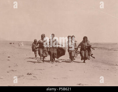 N/A. English:   BPLDC no.: 08 04 000347 Page Title: Child beggars of desert Collection: Tupper Scrapbooks Collection Album: Volume 1: Algeria. Call no.: 4098B.104 v1 (p. 23) Creator: Tupper, William Vaughn Genre: Scrapbooks; Albumen prints Extent: 1 photographic print mounted on page : albumen ; page 33 x 39 cm. Description: Scrapbook page contains one photograph showing a group of children running through the desert. Notes: Page description supplied by cataloger, derived from captions and/or annotated information. BPL Department: Print Department Rights: No known restrictions. Flickr data on  Stock Photo