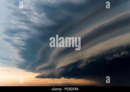 Dramatic rainy sky and dark clouds. Hurricane wind. Strong hurricane over the city. The sky is covered with black storm clouds. Scary sky. Stock Photo