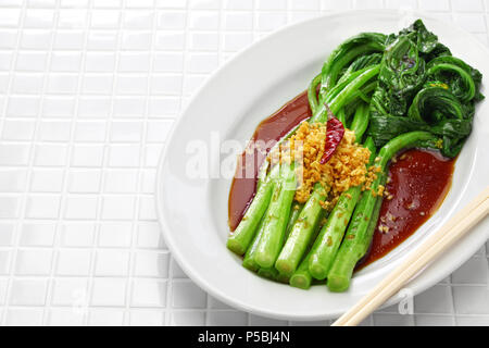 choy sum stir fry with oyster sauce and garlic, chinese cuisine Stock Photo