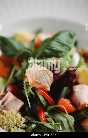Baked salmon in warm salad. close up food photo. Stock Photo