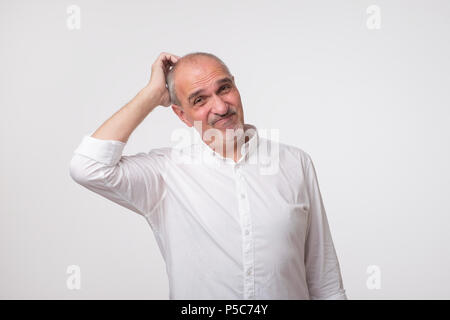 Middle aged man with hand looking up thinking Stock Photo