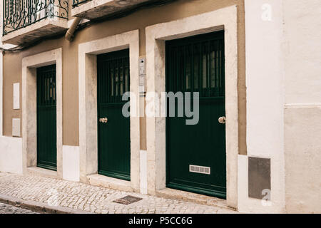 Simple wooden entrance doors are arranged in a row Stock Photo