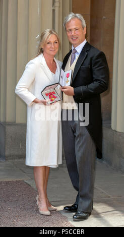 Husband and wife, Nicholas Wheeler and Christian Rucker with their OBEs (Officer of the Most Excellent Order of the British Empire) awarded to them for services to retail, by the Prince of Wales during an investiture ceremony at Buckingham Palace, London. Stock Photo