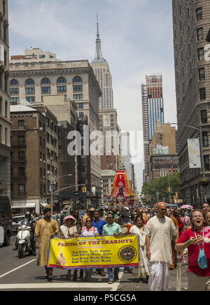 People numbering in the thousands fill 5th Avenue in Manhattan for the 'Festival of the Chariots.' 'Ratha-yatra, or the Festival of Chariots, is a joyous event celebrated for thousands of years in the Indian holy city of Jagannatha Puri, and more recently by Hare Krishna devotees in cities around the world. Stock Photo