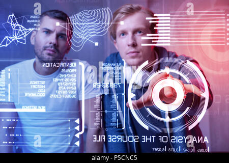 Careful web developers creating a new security system and testing it Stock Photo