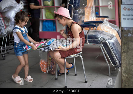 Excited child with a toy. Young brother and sister,  Children Stock Photo