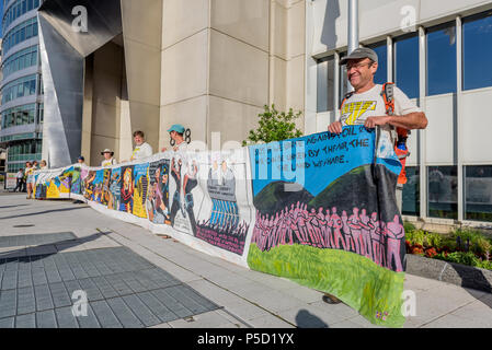 A 50 feet banner was used to block the front door at FERC - Activist group Beyond Extreme Energy partially stop operations at the Federal Energy Regulatory Commission (FERC) headquarters in Washington DC on June 25, 2018, by installing 2 mocked fracking wells and laying an inflatable pipeline on the street outside the employee garage from 7am to early afternoon, successfully preventing them from accessing the workplace. Activists are demanding a halt to the permitting and building of all new fossil fuel pipelines and other infrastructure. (Photo by Erik McGregor/Pacific Press) Stock Photo