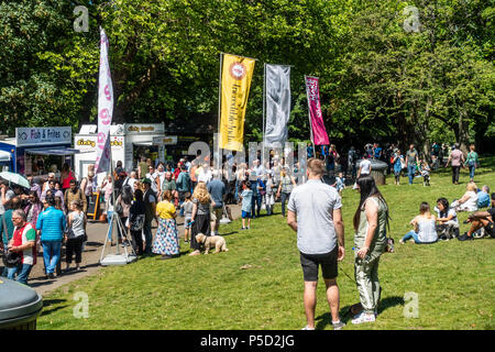 People relaxing, walking or queueing at fast food stalls at Glasgow Mela, 2018, in Kelvingrove Park in the city's West End Stock Photo