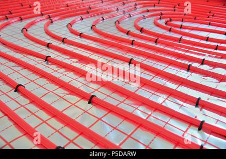 Close-up of water underfloor heating pipes on the silver reflective foil. Stock Photo