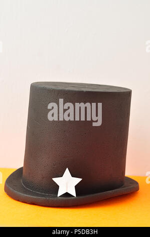 A magicians hat displayed with one silver glitter star Stock Photo