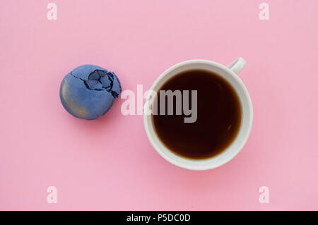 Cup of coffee and macaroons on pink background. Stock Photo