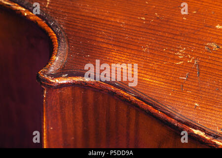 Details of an old dusty cello, closeup view on body wood parts. Stock Photo