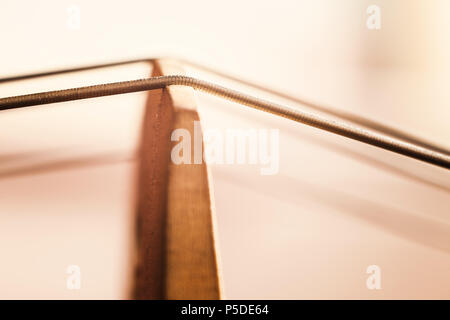 Details of an old dusty cello, closeup view on strings and body. Stock Photo