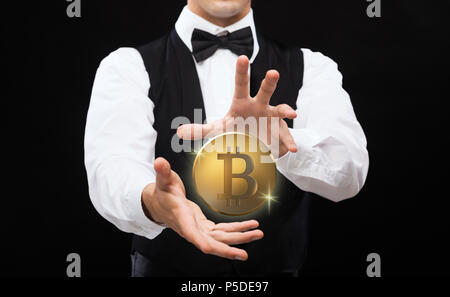 close up of magician with bitcoin over black Stock Photo