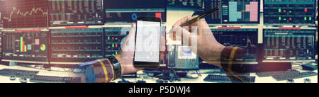 Double exposure of hand holding blank smartphone with Stock market quotes and chart in monitor computer room with business office equipments .business Stock Photo