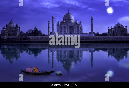 Taj Mahal Agra in full moon night with wooden boat on river Yamuna. Photograph shot from Mehtab Bagh. Stock Photo