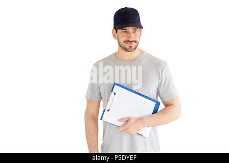 Portrait of young construction worker holding clipboard in his hand while standing at isolated white background. Stock Photo