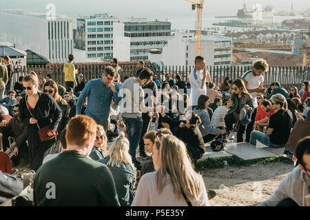 Lisbon, 01 May 2018: Many young people of local people, tourists and migrants on the city lookout platform which is a meeting place for young people and communication between them Stock Photo