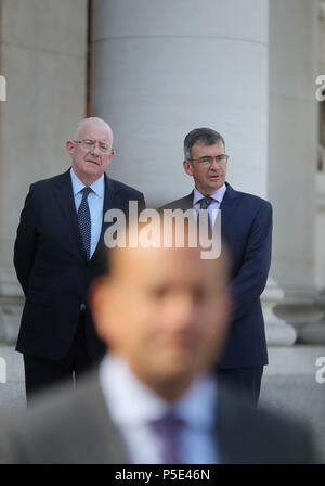 Justice Minister Charles Flannigan (left) at the announcement of Drew Harris (right) as the new Garda Commissioner with Taoiseach Leo Varadkar (front) speaking to the media at the government buildings in Dublin.