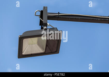 Outdoor single led street light with cable on sky background. Selective focus. Stock Photo
