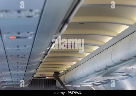 Emergency exit sign on a passenger plane Stock Photo