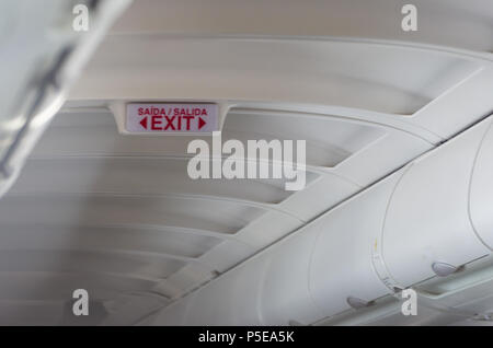 Emergency exit sign on a passenger plane Stock Photo