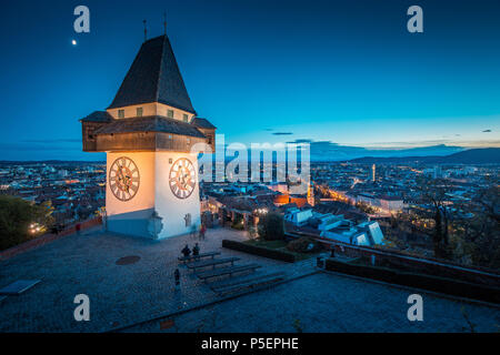 Beautiful twilight view of famous Grazer Uhrturm (clock tower) illuminated during blue hour at dusk, Graz, Styria region, Austria Stock Photo