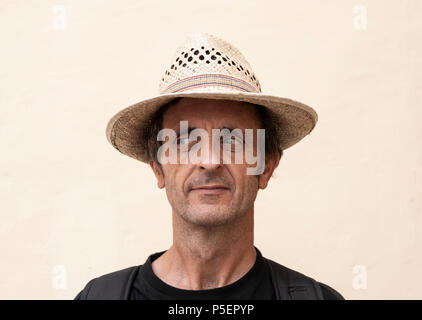 Middle aged male tourist wearing straw hat. Stock Photo