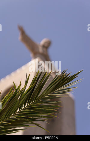 Statue Cristo Rei in lisbon - with palm tree Stock Photo