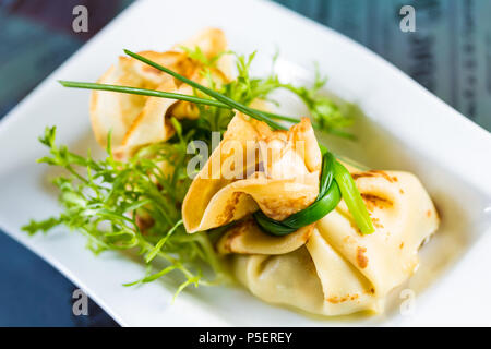 pancakes with meat decorated green onions Stock Photo