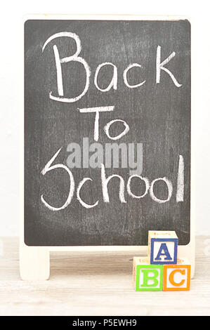 A blackboard with the words Back to School with alphabet blocks ABC Stock Photo