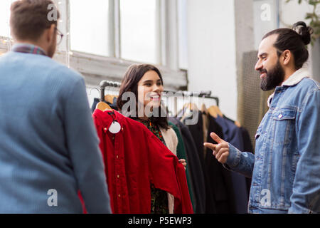 friends choosing clothes at vintage clothing store Stock Photo