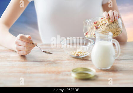 close up of woman eating muesli for breakfast Stock Photo