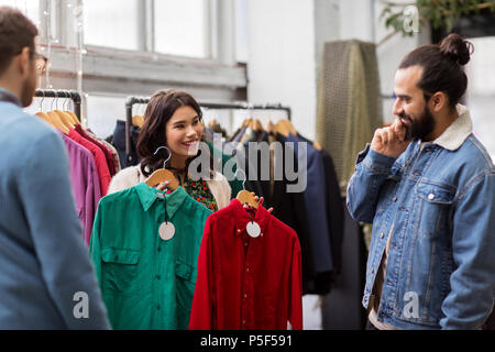 friends choosing clothes at vintage clothing store Stock Photo