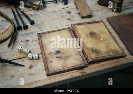 A replica ancient Roman wax writing tablet laid on a table. Stock Photo