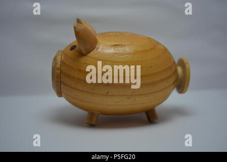 Ukrainian hodgepodge made of natural wood in the form of a pig and placed on a white background. Stock Photo