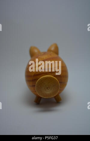 Ukrainian hodgepodge made of natural wood in the form of a pig and placed on a white background. Stock Photo
