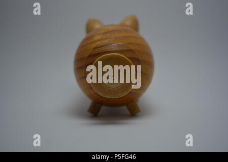 Ukrainian hodgepodge made of natural wood in the form of a pig and placed on a white background. Stock Photo