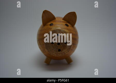 Ukrainian hodgepodge made of natural wood in the form of a pig and placed on a white background. Stock Photo