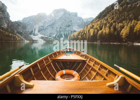 Beautiful view of traditional wooden rowing boat on scenic Lago di Braies in the Dolomites in scenic morning light at sunrise, South Tyrol, Italy Stock Photo