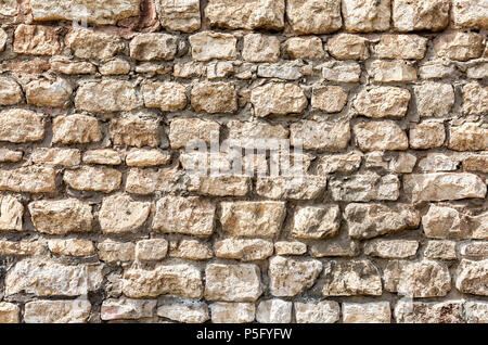 Weathered grey stone wall as creative background texture Stock Photo