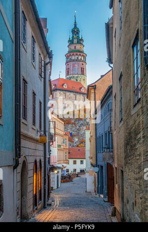 Beautiful alley scene with Cesky Krumlov Castle in the background in the historic city of Cesky Krumlov in morning twilight at dawn, Czech Republic Stock Photo